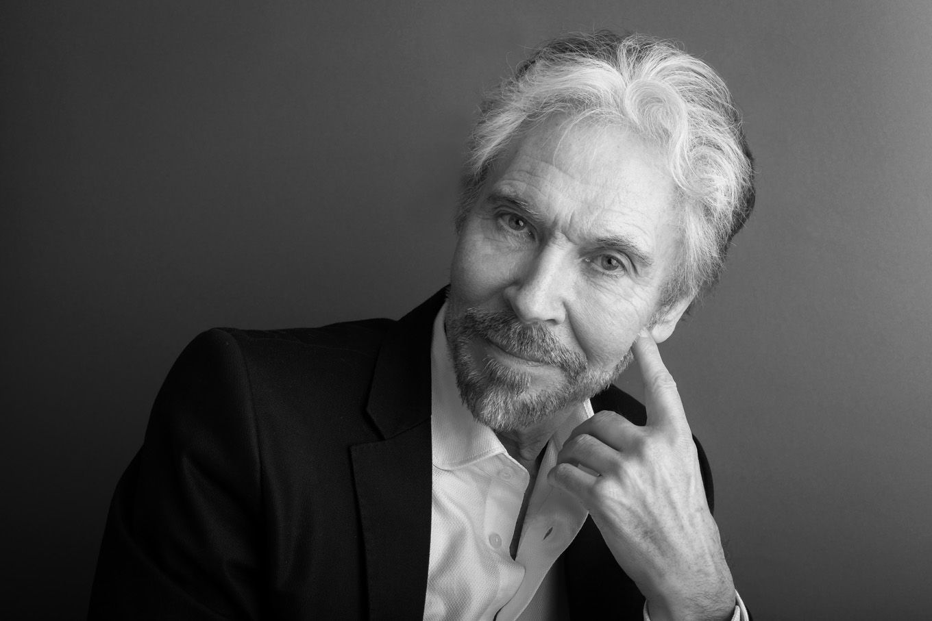 A portrait of an actor taken in a studio set up with backdrop and lighting equipment